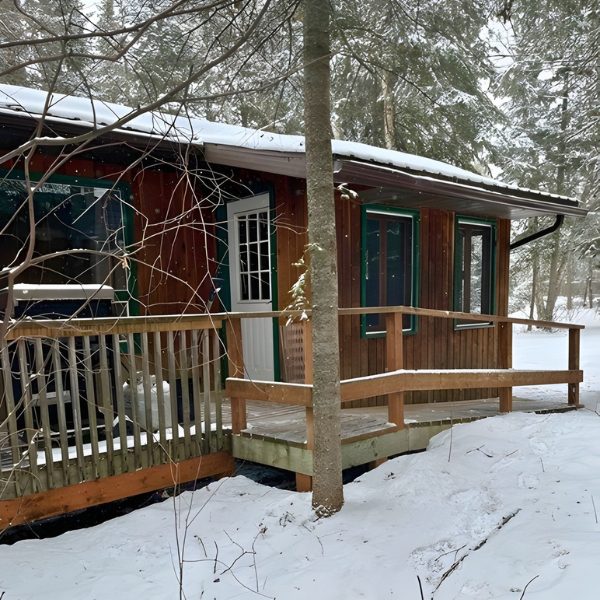 Exterior image of Chalet 10 at Inverness Falls resort in the winter, featuring the wheelchair ramp for accessibility.