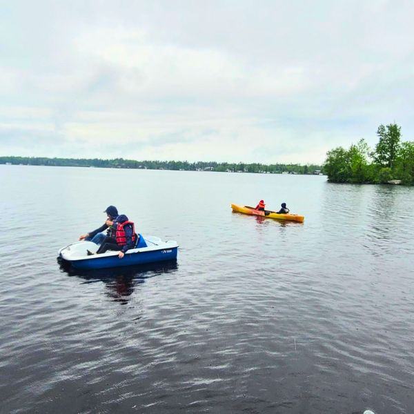 Families using a peddle boat and kayak on Brereton Lake.