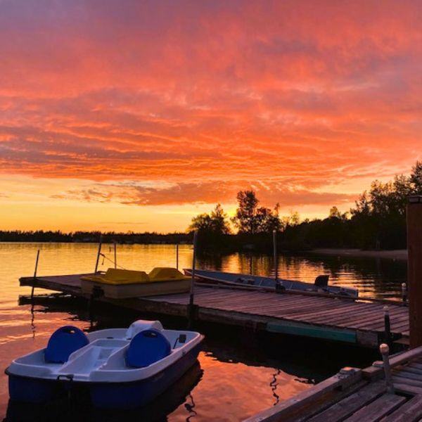 The Inverness Falls Resort dock and peddle boat during sunset, setting the stage for family fun.