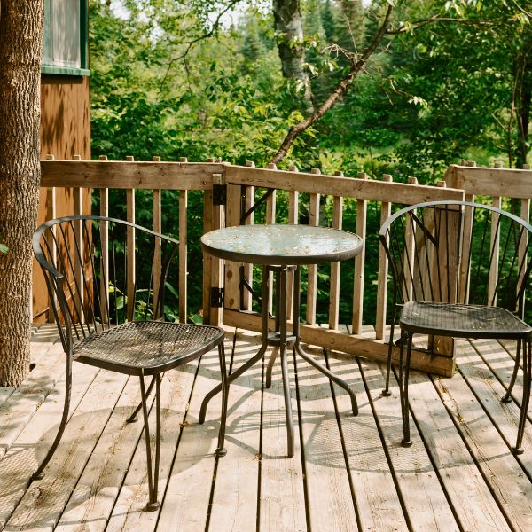 Patio chairs and a table on the deck, where couples can pull up a seat for a meal or relaxed afternoon during their honeymoon packages.