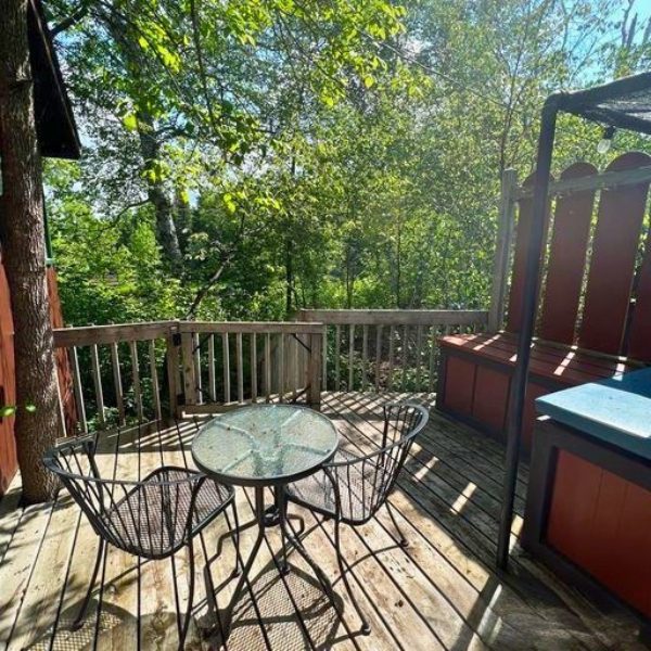 Exterior image of Lakeview Cabin 7 at Inverness Falls Resort featuring the outdoor coffee nook on the deck.