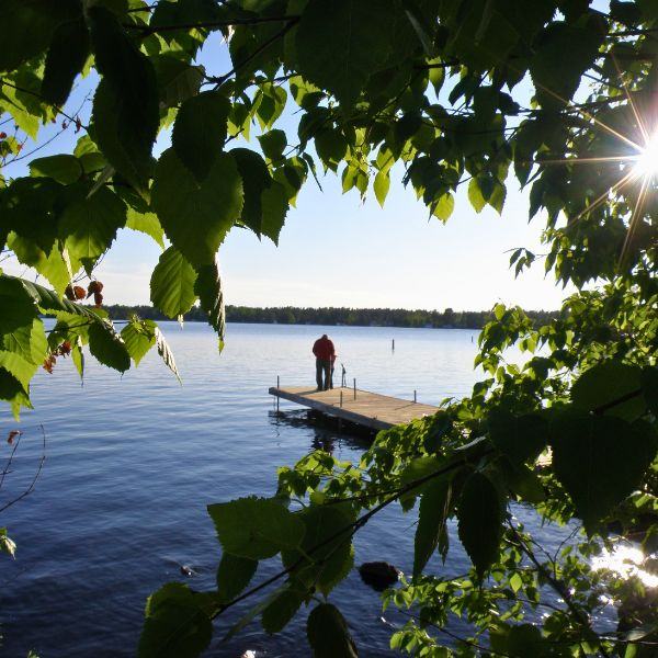 A person standing on Inverness' dock prepping a fishing rod, highlighting what personal retreats are all about.