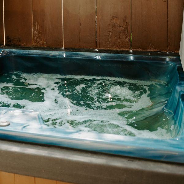 The outdoor hot tub at Cabin 7, which makes a great accommodation for personal retreats at Inverness Falls Resort.