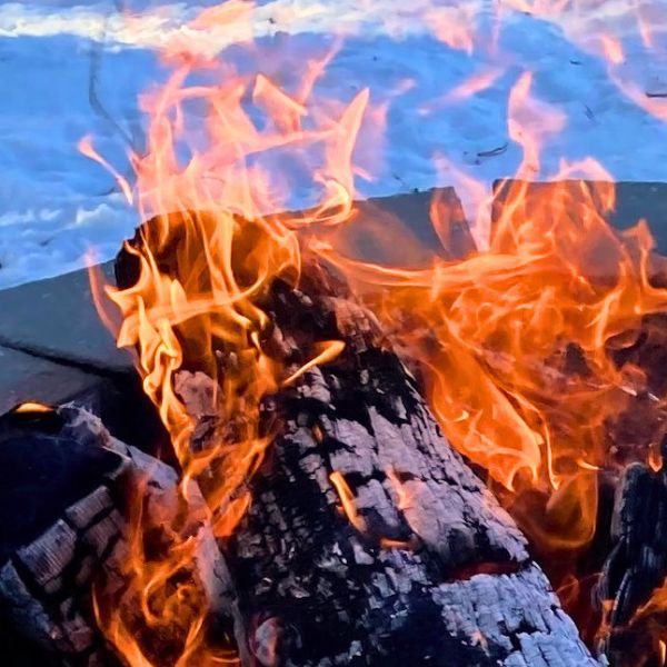 A bonfire at Inverness Falls Resort's riverside bonfire area, a great spot to enjoy nature or meet other guests during personal retreats.