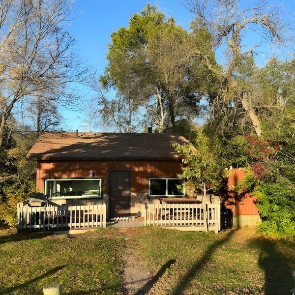 Exterior of Cabin 6 in summertime, a great option for romantic getaways.